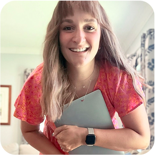 Shelley Cerny smiling, holding a laptop