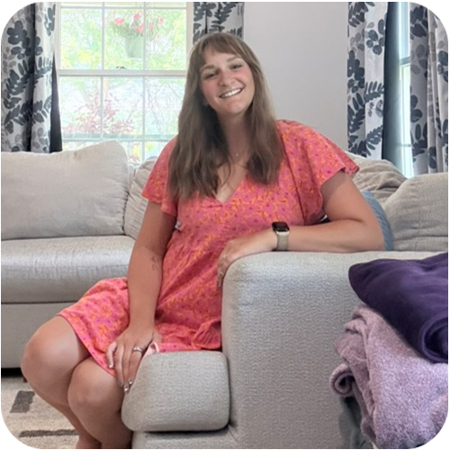 Shelley Cerny smiling, sitting on a couch